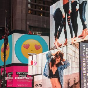 Colorful billboards light up New York City's iconic Times Square at night, with vibrant ads and bustling crowds.